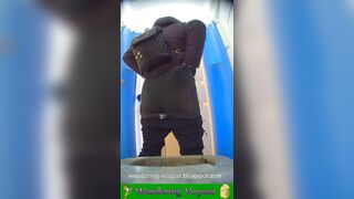 Girls peeing in a urinal