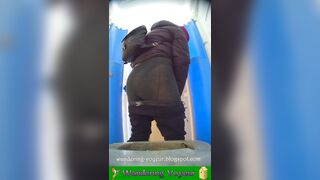 Girls peeing in a urinal