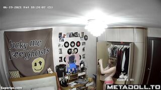American blonde teen girl gets dressed in her room