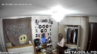 American blonde teen girl gets dressed in her room