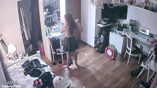 Freckled teen girl gets dressed in her room