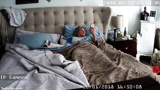 American blonde woman masturbates while watching porn