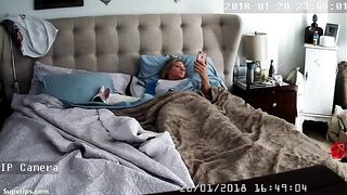 American blonde woman masturbates while watching porn