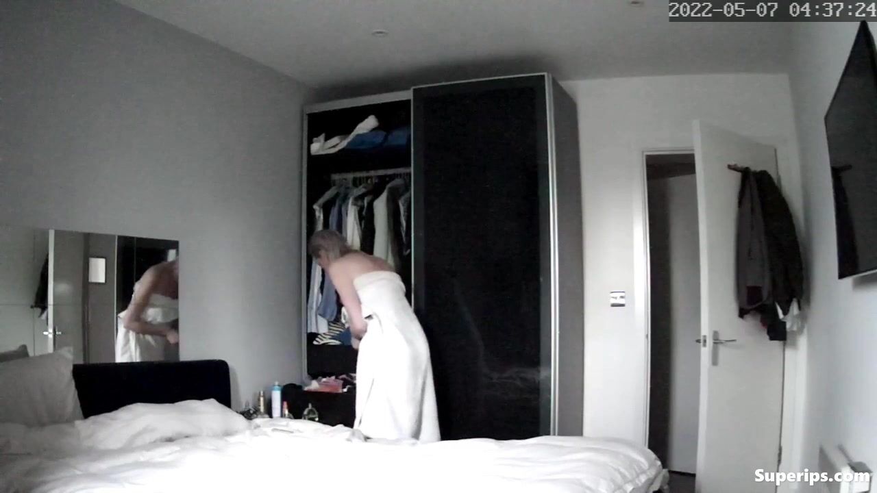 British blonde girl gets dressed in her room