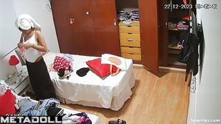 Young brunette girl gets dressed in her room