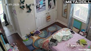 Tanned teenage girl gets dressed in her room