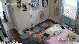 Tanned teenage girl gets dressed in her room