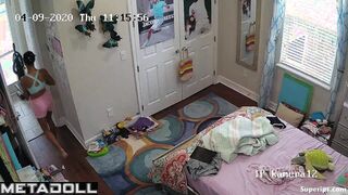 Tanned teenage girl gets dressed in her room