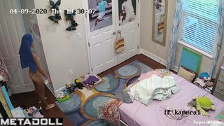 Cute skinny girl changes clothes in her room