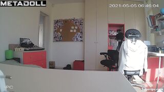 Blonde girl with glasses gets dressed in her room