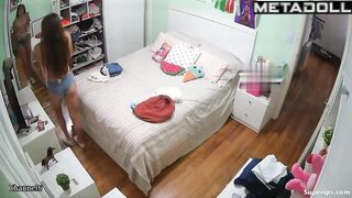 Petite European girl gets dressed in her room