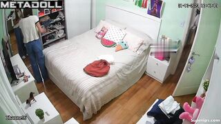 Petite European girl gets dressed in her room