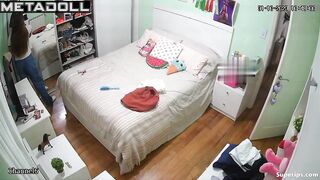 Petite European girl gets dressed in her room