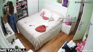 Petite European girl gets dressed in her room