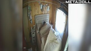 Wife and husband having fun in bed in village house