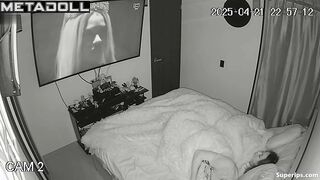 Couple enjoys cozy sex under a blanket in the background of a movie on tv