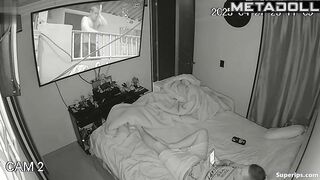 Couple enjoys cozy sex under a blanket in the background of a movie on tv