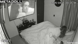 Couple enjoys cozy sex under a blanket in the background of a movie on tv