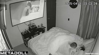 Couple enjoys cozy sex under a blanket in the background of a movie on tv