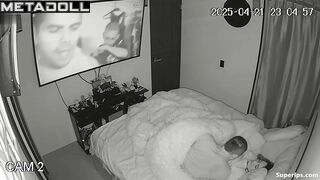 Couple enjoys cozy sex under a blanket in the background of a movie on tv