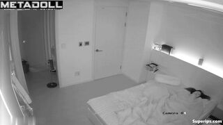 Asian couple making awkward movements in bed, look