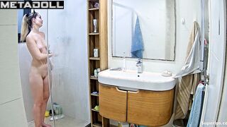 Pretty blonde playing solo game in the shower cabin