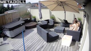 Spouses teasing each other on the sunny terrace, look
