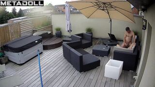 Spouses kissing on the balcony by the break of day