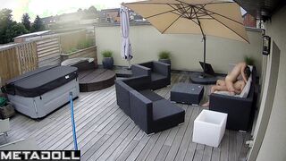 Spouses kissing on the balcony by the break of day