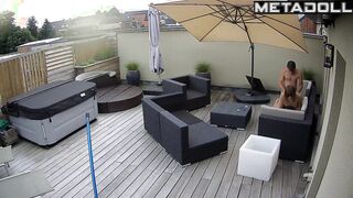 Spouses kissing on the balcony by the break of day