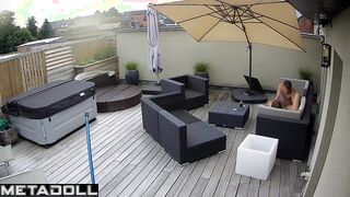 Spouses kissing on the balcony by the break of day
