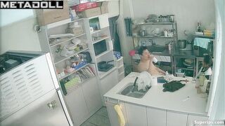 Asian kitchen workers fooling around in a restaurant kitchen