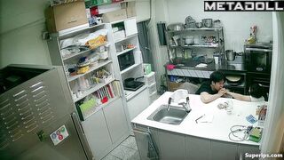 Asian kitchen workers fooling around in a restaurant kitchen