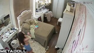 A beautiful naked girl admires herself while looking in the mirror