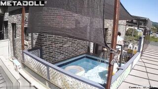 Asian couple enjoying swimming together (inflatable pool in the yard)