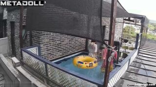 Asian couple enjoying swimming together (inflatable pool in the yard)
