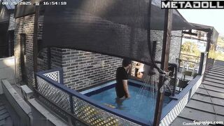 Asian couple enjoying swimming together (inflatable pool in the yard)