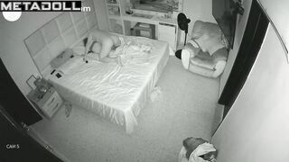 An excited tattooed man molests his sleeping skinny wife