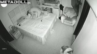 An excited tattooed man molests his sleeping skinny wife