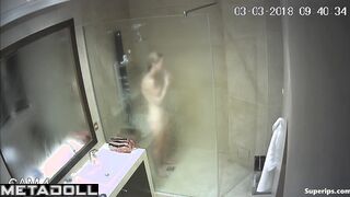 A skinny young blonde with small seductive tits takes a shower