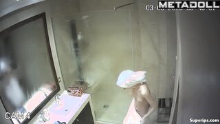 A skinny young blonde with small seductive tits takes a shower