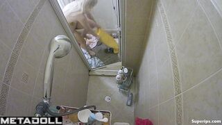 A slender blonde gently caresses her body while taking a shower