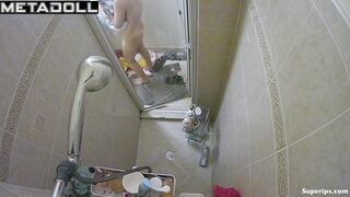 A slender blonde gently caresses her body while taking a shower