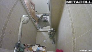 A slender blonde gently caresses her body while taking a shower