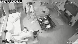 Two naked couples have intercourse in the living room while watching TV