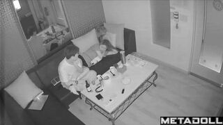 Young boyfriend kisses and caresses his Asian girlfriend in a karaoke room