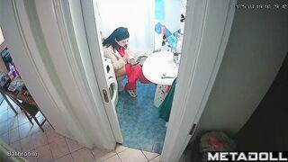 Young brunette peeing and brushing her teeth at the same time