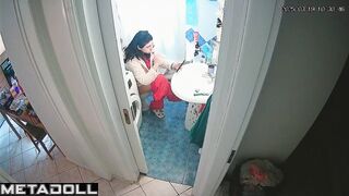 Young brunette peeing and brushing her teeth at the same time