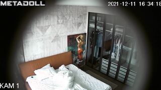 While she is resting on the bed, her husband is watching it