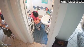 Lady's sitting on the toilet in funny pajamas, look